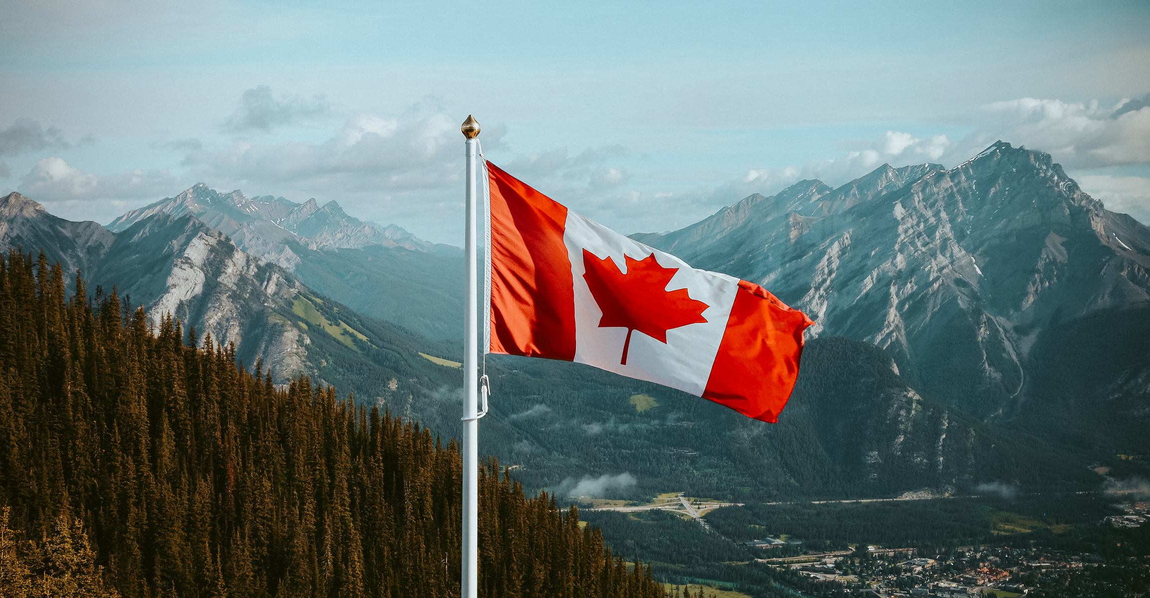 Canadian flag with mountains in background