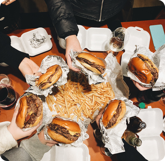 A table filled with quick service restaurant food and drinks.